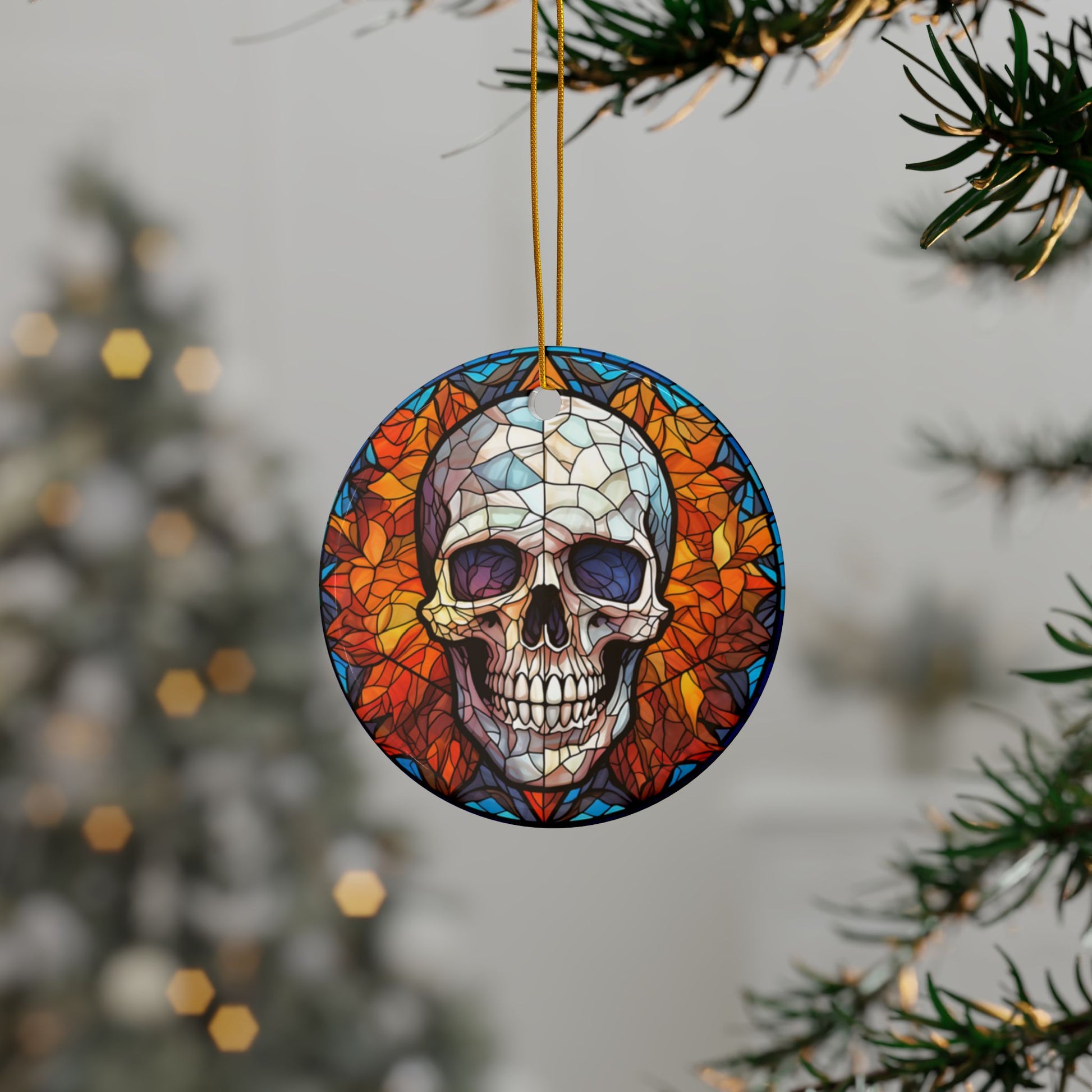 Decorative skull ornament with stained glass effect hanging on a tree branch.