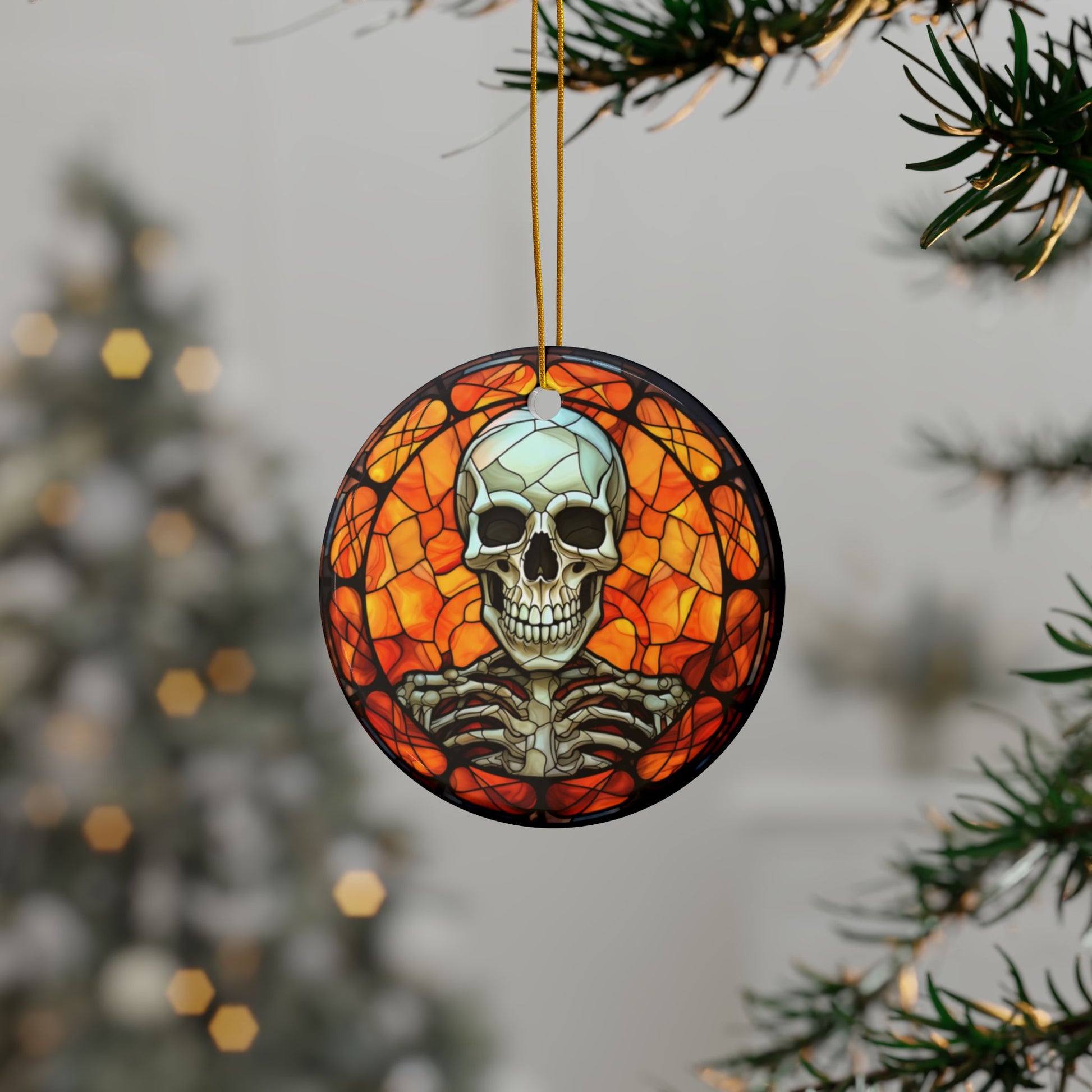 Decorative ornament with a skull and skeleton design hanging on a tree branch.