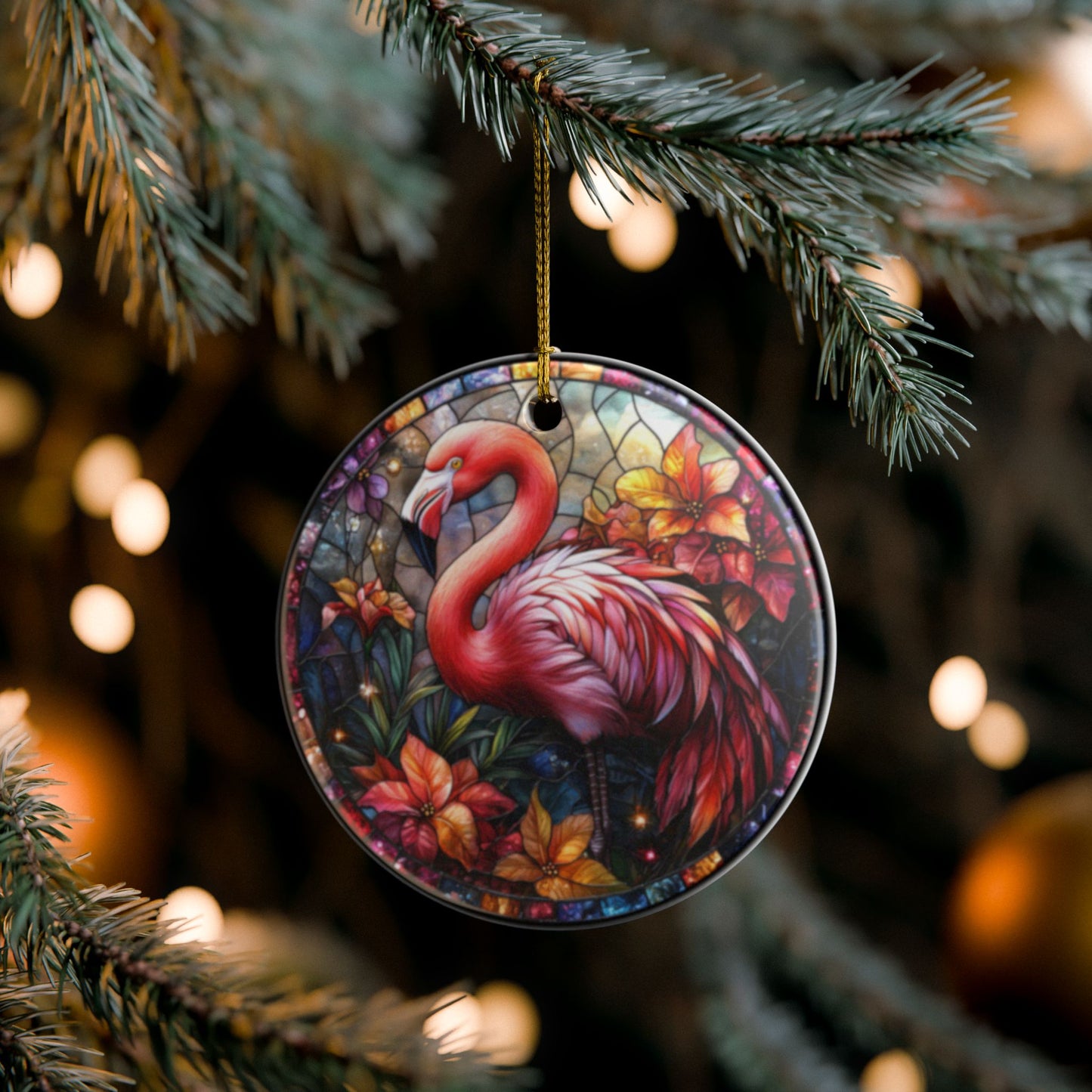 Decorative flamingo ornament hanging on a Christmas tree with blurred lights in the background.